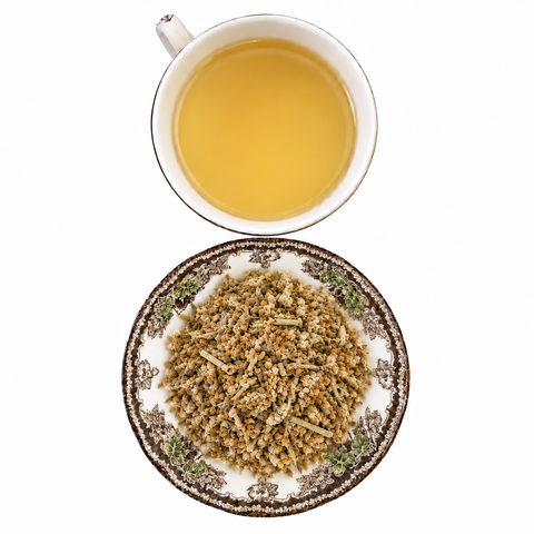 Yarrow Flower, Organic loose dried herb on a floral transferware plate with a cup of steeped infusion