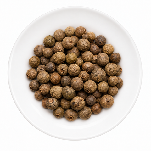 Allspice, Whole dry spice on a plain white plate against a white background