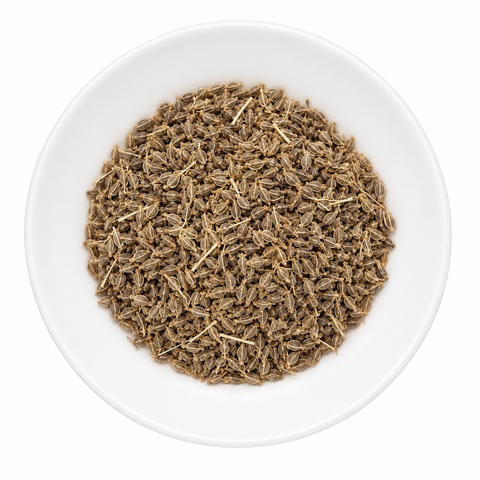 Anise Seed, Whole dry spice on a plain white plate against a white background