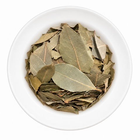 Bay Leaf, whole dry spice on a plain white plate against a white background