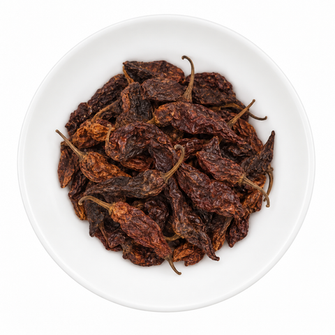 Bhut Jolokia Pepper dry spice on a plain white plate against a white background