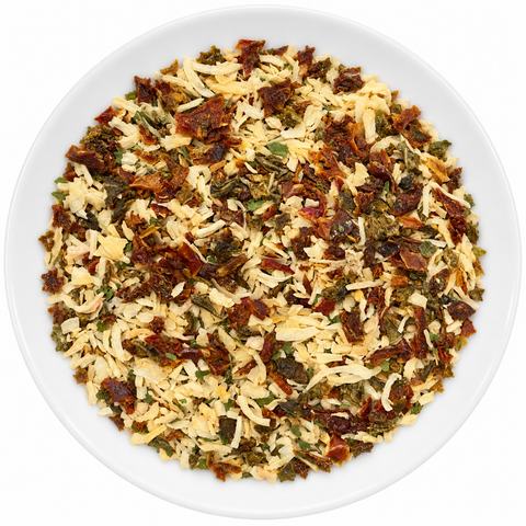 Sofrito dry spice on a plain white plate against a white background
