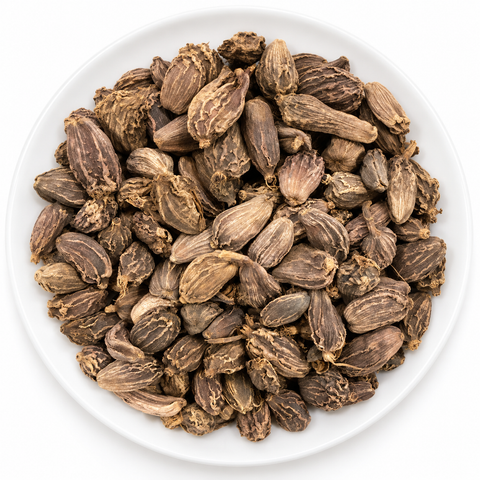 Black Cardamom Pods dry product on a plain white plate against a white background