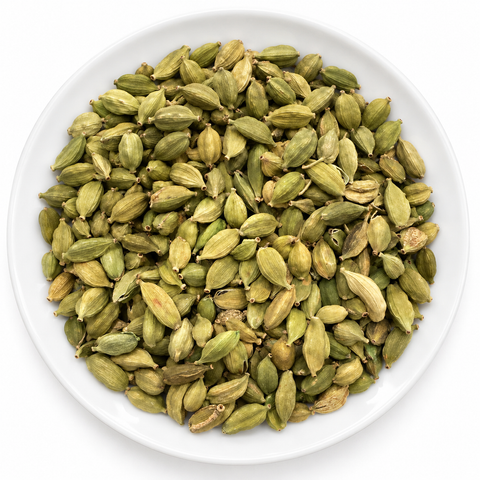 Cardamom, Green Whole dry product on a plain white plate against a white background