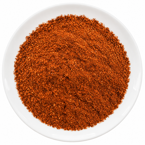 Chili Pepper Powder dry product on a plain white plate against a white background