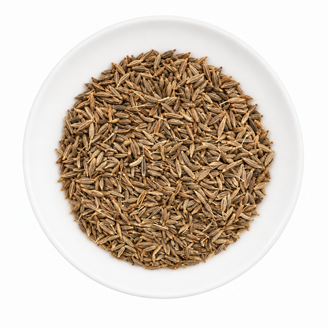 Cumin Seed, whole dry product on a plain white plate against a white background