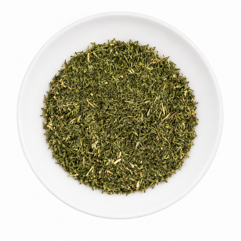 Dill Weed dry product on a plain white plate against a white background