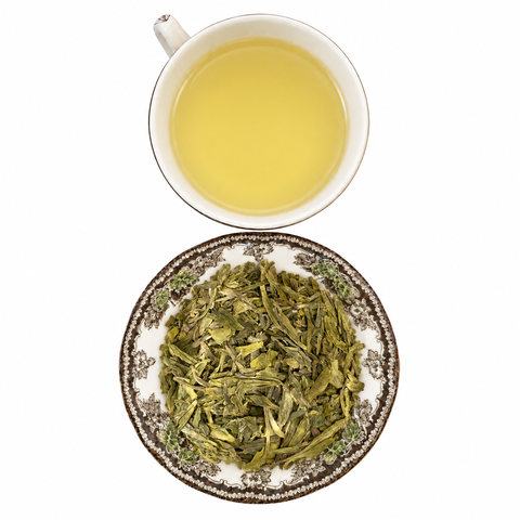 Dragon Well Organic loose-leaf tea with brewed tea on a white background