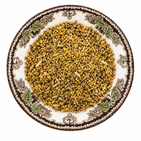 Fennel Pollen dry product on a floral transferware plate against a white background