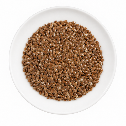 Flax Seed, whole dry product on a plain white plate against a white background