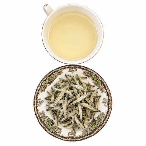 Imperial Yunnan Silver Needle loose-leaf tea with brewed tea on a white background