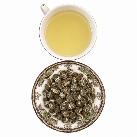 Jasmine Pearls loose-leaf tea with brewed tea on a white background