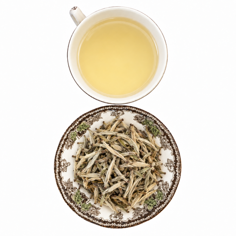 Jasmine Yin Zhen Silver Needle loose-leaf tea with brewed tea on a white background