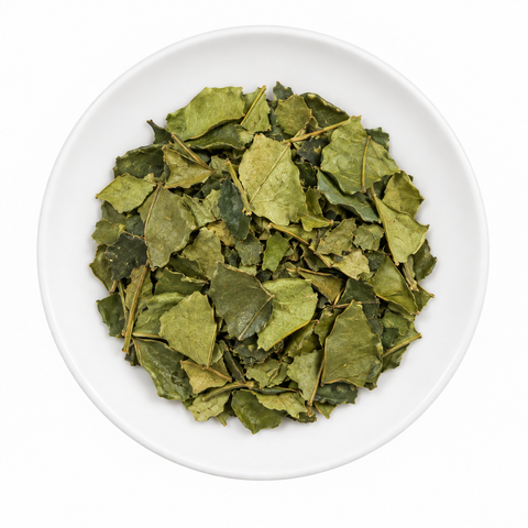 Kaffir Lime Leaves dry product on a plain white plate against a white background