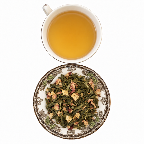Lychee Rose Green loose-leaf tea with brewed tea on a white background