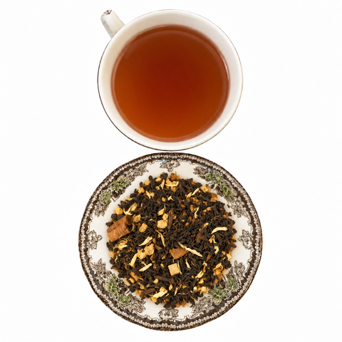 Maple Chai Pu'erh loose-leaf tea with brewed tea on a white background