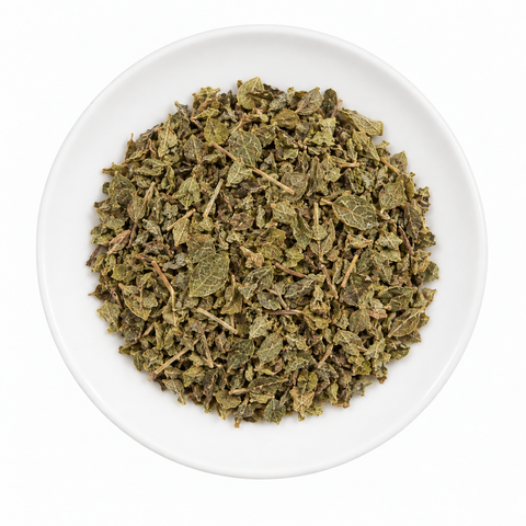 Oregano (Mexican) dry product on a plain white plate against a white background