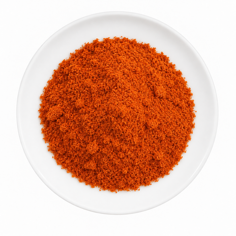 Paprika (Hungary) Powder dry product on a plain white plate against a white background