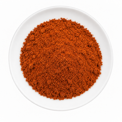 Paprika, Smoked Spanish dry product on a plain white plate against a white background
