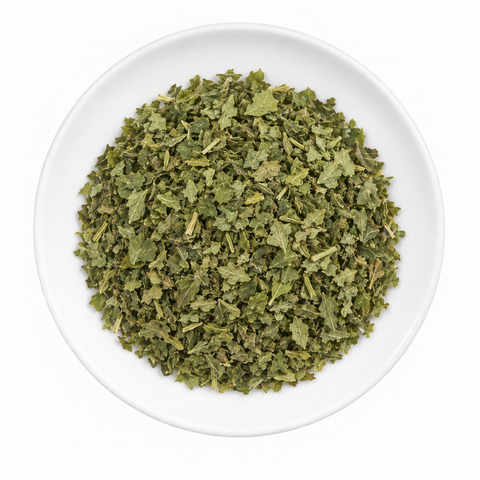 Parsley, flake dry product on a plain white plate against a white background