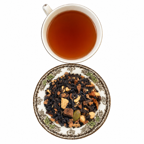 Pumpkin Spice Chai loose-leaf tea with brewed tea on a white background