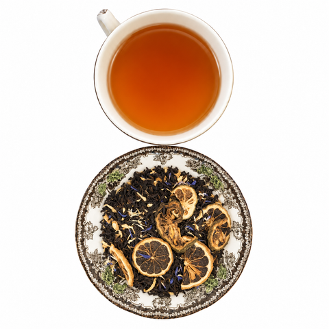 Ritzy Cream Earl Grey loose-leaf tea with brewed tea on a white background