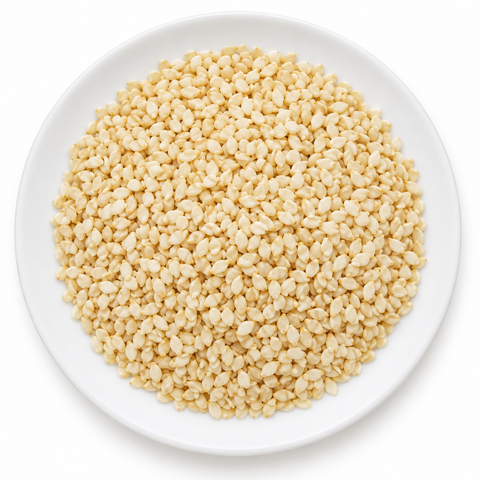 Sesame Seed, Hulled dry product on a plain white plate against a white background