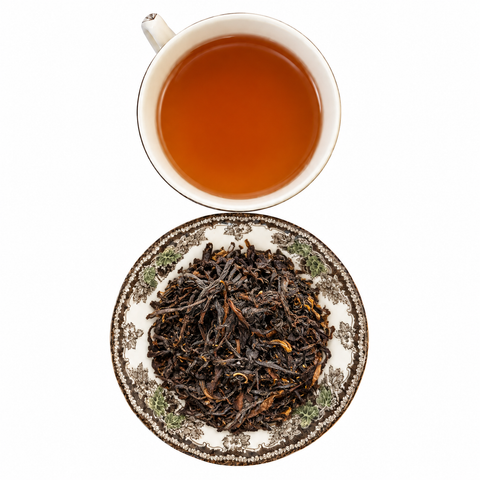 Yunnan Black loose-leaf tea with brewed tea on a white background