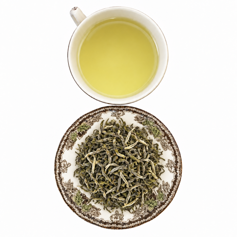 Yunnan Green Winter 1st Flush loose-leaf tea with brewed tea on a white background