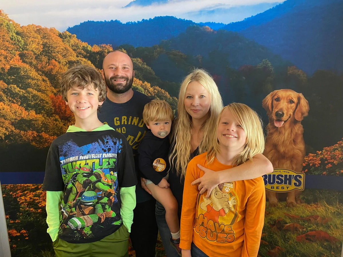 The Strahler family together in front of a mountain backdrop.
